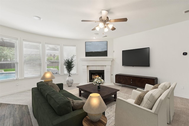 3442 Overhill Dr, Frisco, TX 75033 - living room featuring ceiling fan, carpet, and a warm lit fireplace