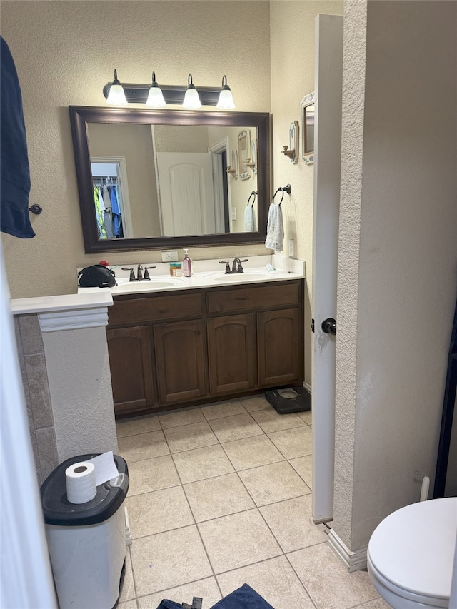 124 Brady Coleman Ln, Springtown, TX 76082 - bathroom with a textured wall, tile patterned flooring, and double vanity