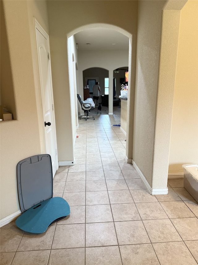 124 Brady Coleman Ln, Springtown, TX 76082 - hallway featuring arched walkways and light tile patterned floors