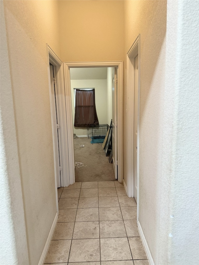 124 Brady Coleman Ln, Springtown, TX 76082 - corridor with light tile patterned floors, a textured wall, and light carpet