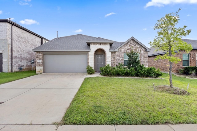 521 Bermuda Ave, Lancaster, TX 75146 - french country style house featuring a garage, a front yard, brick siding, a shingled roof, and driveway