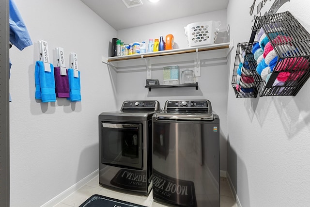 521 Bermuda Ave, Lancaster, TX 75146 - laundry room featuring washing machine and dryer and tile patterned flooring