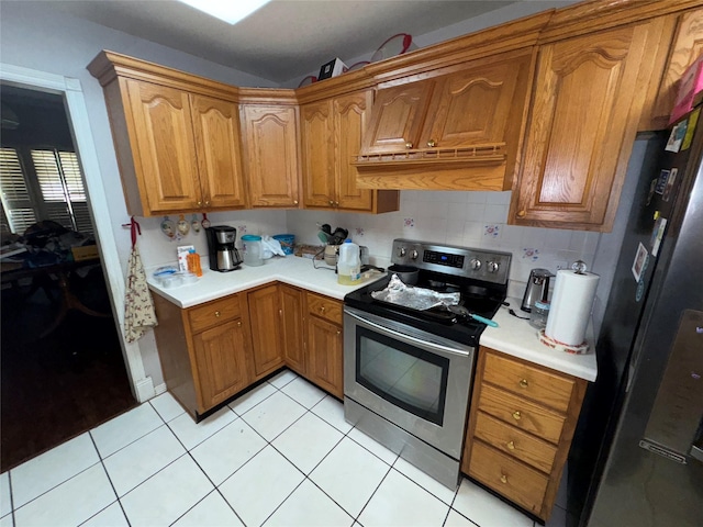 2720 Dorothy Dr, Keene, TX 76031 - kitchen featuring appliances with stainless steel finishes, brown cabinets, and light countertops