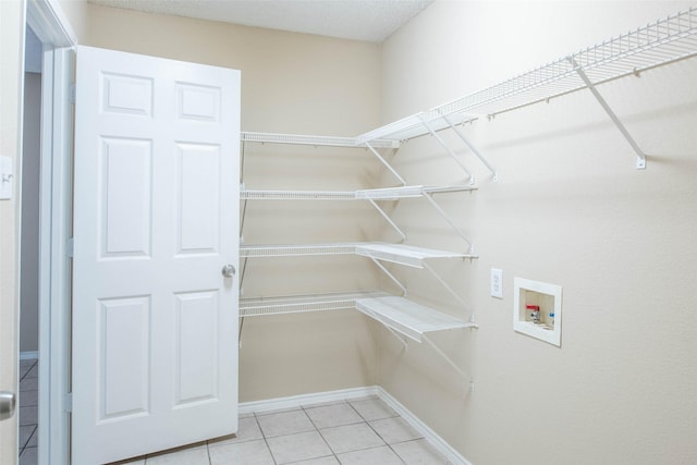 1565 Laurel Hall Ln, Little Elm, TX 75068 - laundry area with washer hookup and light tile patterned floors