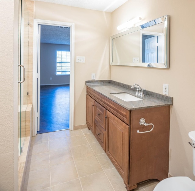 1565 Laurel Hall Ln, Little Elm, TX 75068 - full bathroom featuring vanity, a stall shower, and tile patterned flooring