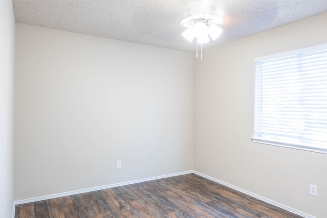 1565 Laurel Hall Ln, Little Elm, TX 75068 - spare room featuring dark wood-style floors, plenty of natural light, ceiling fan, and a textured ceiling