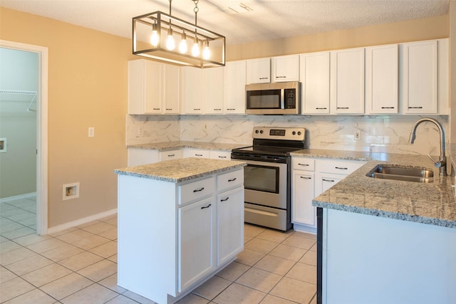 1565 Laurel Hall Ln, Little Elm, TX 75068 - kitchen with appliances with stainless steel finishes, light tile patterned floors, decorative backsplash, light stone countertops, and a textured ceiling
