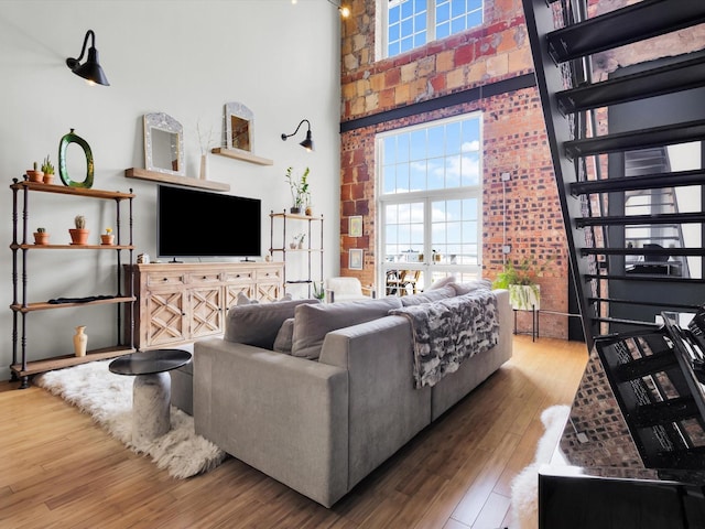 1122 Jackson St Unit 1103, Dallas, TX 75202 - living room with a high ceiling, wood-type flooring, and healthy amount of natural light