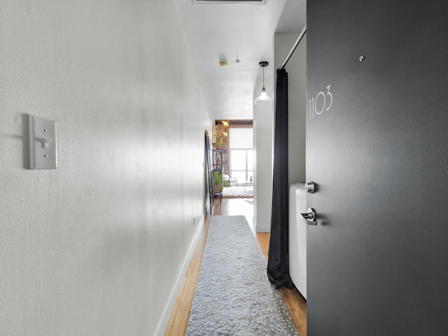1122 Jackson St Unit 1103, Dallas, TX 75202 - hallway with light wood finished floors and baseboards