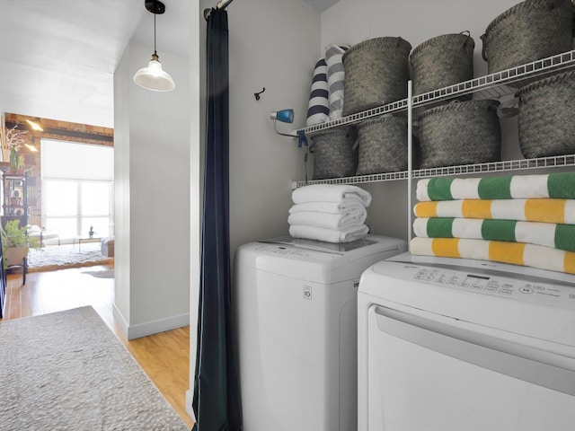 1122 Jackson St Unit 1103, Dallas, TX 75202 - laundry area featuring washer and dryer and wood finished floors