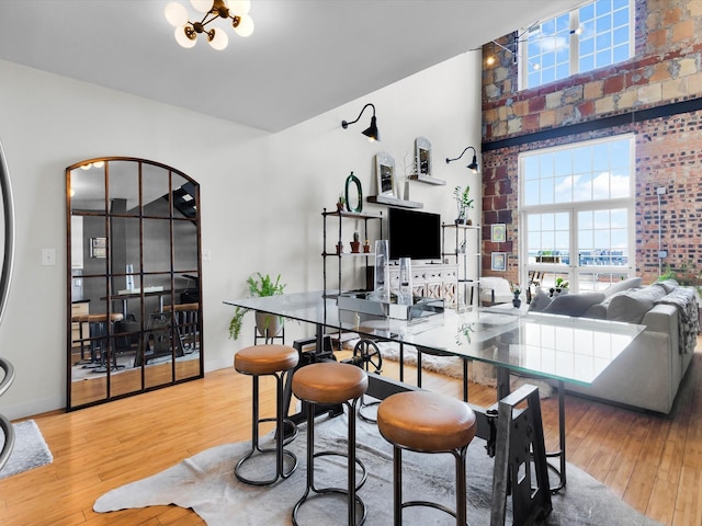 1122 Jackson St Unit 1103, Dallas, TX 75202 - dining area featuring wood-type flooring and a high ceiling