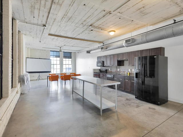 1122 Jackson St Unit 1103, Dallas, TX 75202 - kitchen with stainless steel appliances, dark brown cabinetry, finished concrete flooring, and tasteful backsplash