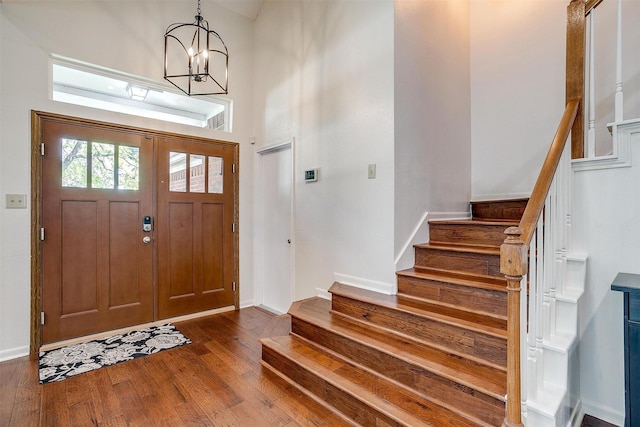 609 Huntington Ct, Grapevine, TX 76051 - foyer entrance with stairs, dark wood-type flooring, a chandelier, and a high ceiling