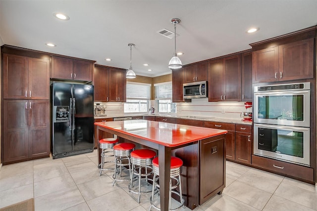 609 Huntington Ct, Grapevine, TX 76051 - kitchen featuring black appliances, tasteful backsplash, recessed lighting, a kitchen island, and light tile patterned floors