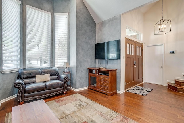 609 Huntington Ct, Grapevine, TX 76051 - living room featuring wood finished floors, healthy amount of natural light, a chandelier, and high vaulted ceiling