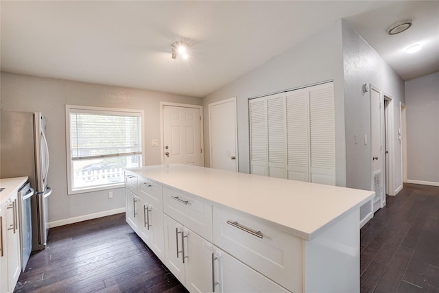 5712 Hudson St, Dallas, TX 75206 - kitchen featuring dark wood-style floors, white cabinets, light countertops, a center island, and vaulted ceiling