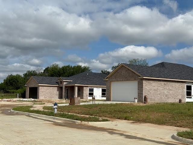 10105 Budtime Ln, Dallas, TX 75217 - ranch-style house featuring a garage, concrete driveway, and brick siding