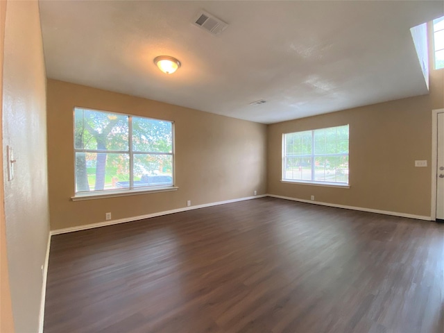 1125 Greenbend Dr, Denton, TX 76210 - unfurnished room with dark wood-style floors and baseboards