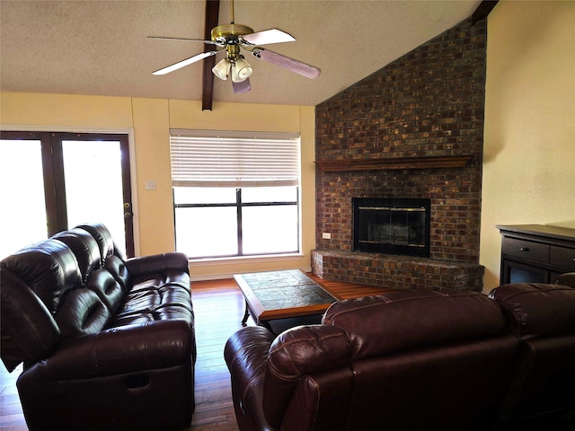 170 N Meadowbrook Dr, Pottsboro, TX 75076 - living room featuring lofted ceiling, wood-type flooring, a ceiling fan, a fireplace, and a textured ceiling