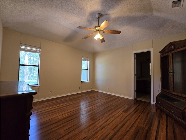 170 N Meadowbrook Dr, Pottsboro, TX 75076 - unfurnished bedroom featuring dark wood finished floors, a textured ceiling, a ceiling fan, and ensuite bath