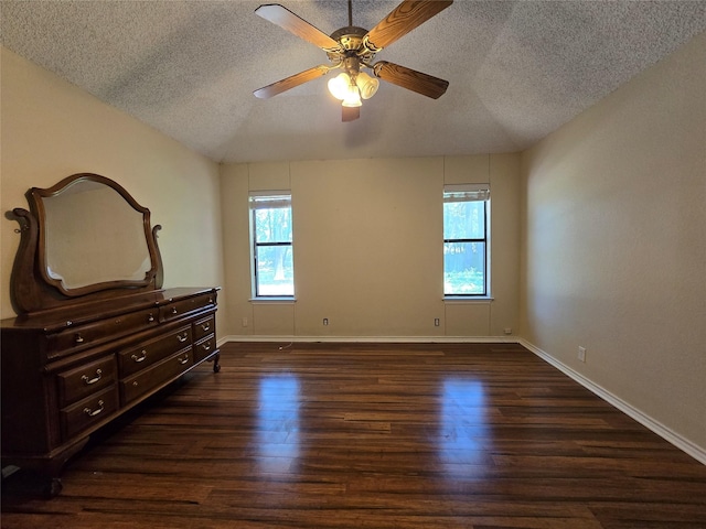 170 N Meadowbrook Dr, Pottsboro, TX 75076 - unfurnished bedroom featuring a textured ceiling, multiple windows, wood finished floors, vaulted ceiling, and a ceiling fan