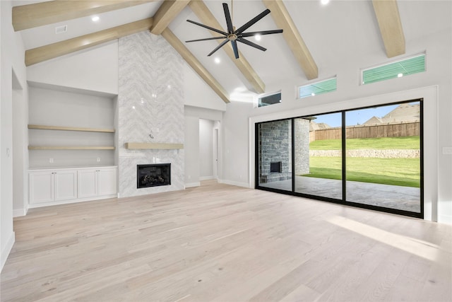 232 Bel Grand Rd, Haslet, TX 76052 - unfurnished living room featuring a high end fireplace, light wood finished floors, beam ceiling, and high vaulted ceiling