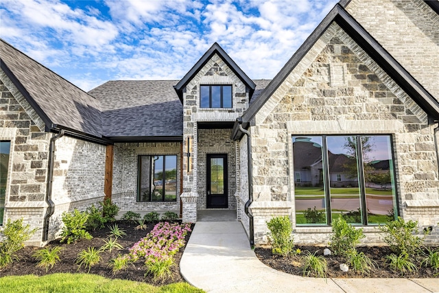 232 Bel Grand Rd, Haslet, TX 76052 - doorway to property featuring a shingled roof, stone siding, and brick siding