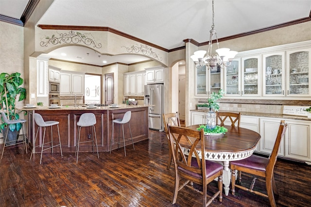 5101 Oak Timbers Ct, Colleyville, TX 76034 - dining area with arched walkways, a chandelier, dark wood-style flooring, ornamental molding, and lofted ceiling