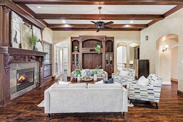 5101 Oak Timbers Ct, Colleyville, TX 76034 - living room with arched walkways, beam ceiling, wood finished floors, ceiling fan, and a tiled fireplace