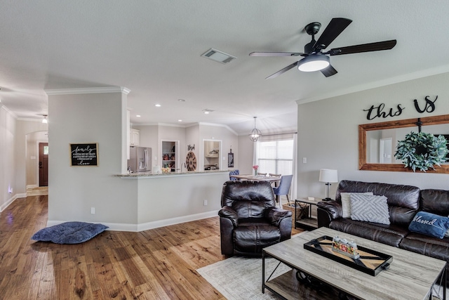 785 Crockett Dr, Lavon, TX 75166 - living area with crown molding, a ceiling fan, wood finished floors, arched walkways, and recessed lighting