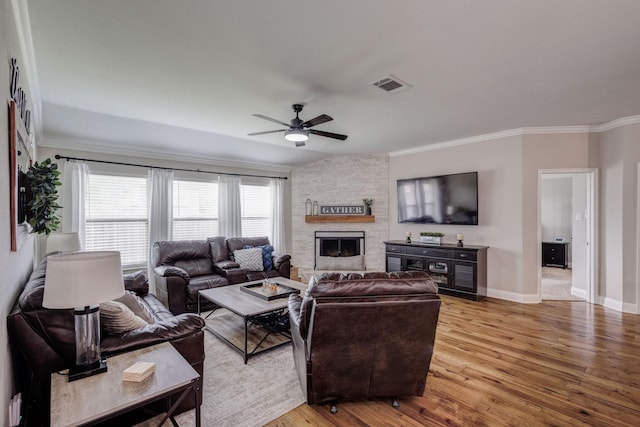 785 Crockett Dr, Lavon, TX 75166 - living room with a ceiling fan, ornamental molding, light wood-style flooring, and a stone fireplace