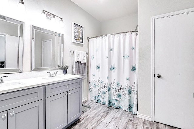 7400 Howling Coyote Ln, Fort Worth, TX 76131 - bathroom featuring double vanity, wood finished floors, and a shower with curtain