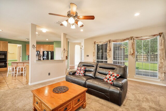 9513 Tiger Dr, Plano, TX 75025 - living area featuring light colored carpet, ceiling fan, recessed lighting, light tile patterned flooring, and arched walkways