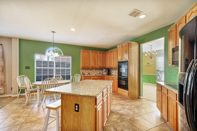 9513 Tiger Dr, Plano, TX 75025 - kitchen featuring a chandelier, black appliances, tasteful backsplash, a kitchen island, and light tile patterned flooring