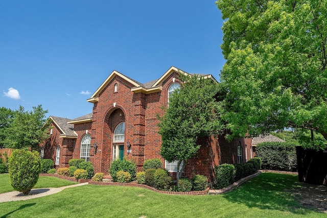 9513 Tiger Dr, Plano, TX 75025 - traditional-style house with a front lawn and brick siding