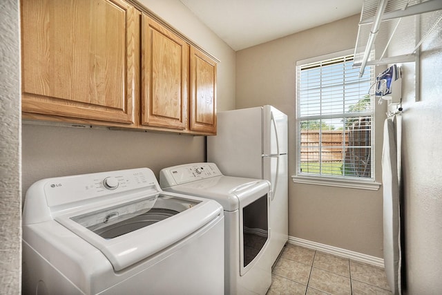 9513 Tiger Dr, Plano, TX 75025 - washroom featuring separate washer and dryer, cabinet space, healthy amount of natural light, and light tile patterned flooring