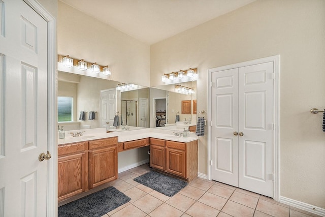 9513 Tiger Dr, Plano, TX 75025 - bathroom featuring tile patterned flooring, double vanity, and a shower with door