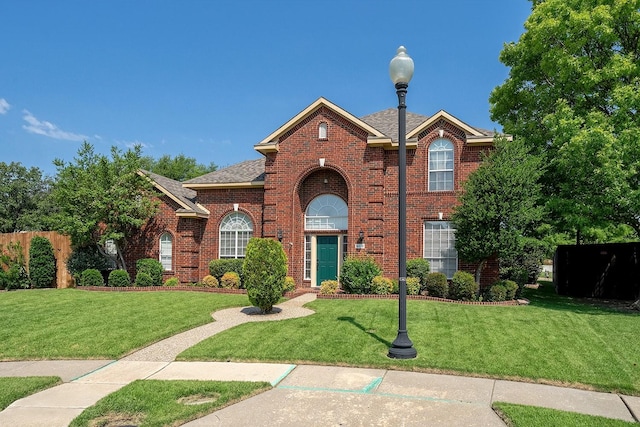 9513 Tiger Dr, Plano, TX 75025 - view of front of house featuring brick siding, a front yard, and a shingled roof