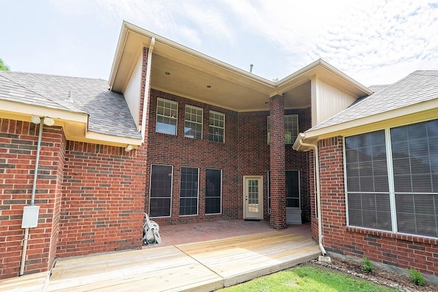 9513 Tiger Dr, Plano, TX 75025 - rear view of property with a wooden deck, brick siding, and roof with shingles