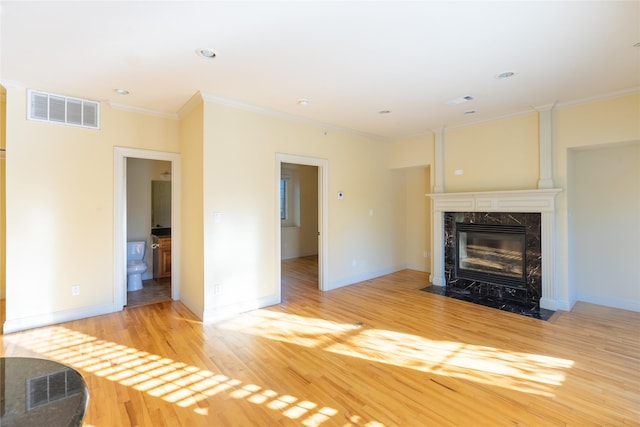 2203 N Carroll Ave Unit 1, Dallas, TX 75204 - unfurnished living room featuring wood finished floors, a high end fireplace, ornamental molding, and recessed lighting