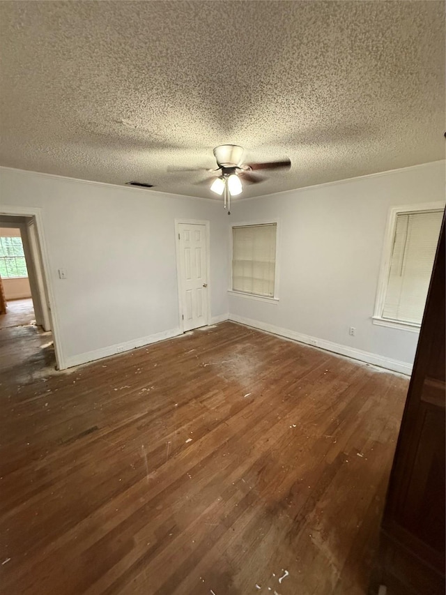 709 Highland Dr, Palestine, TX 75801 - empty room featuring a textured ceiling, a ceiling fan, and hardwood / wood-style floors