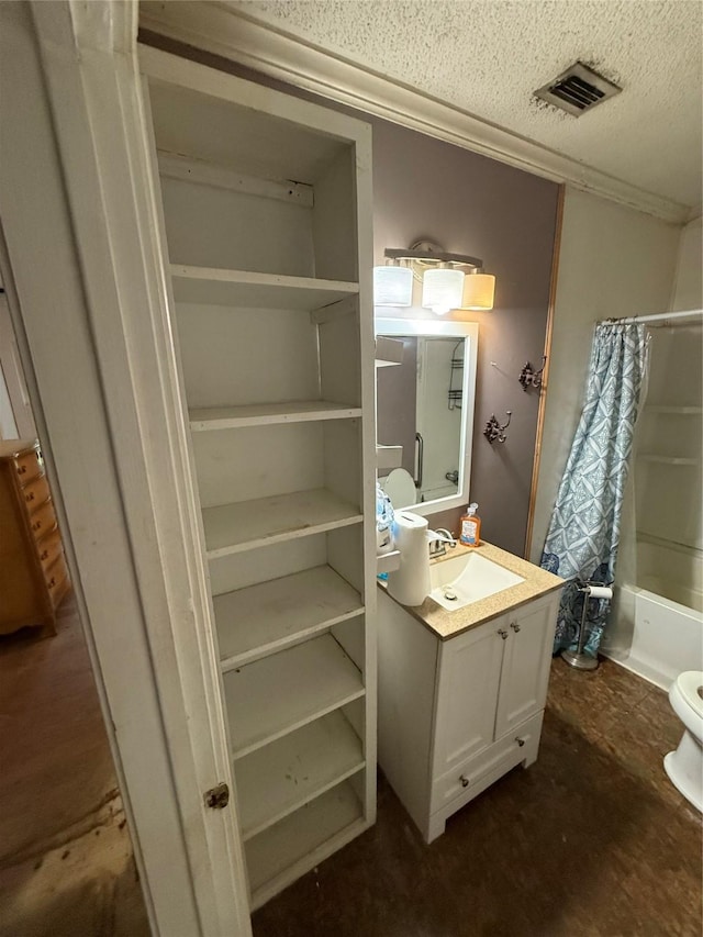 709 Highland Dr, Palestine, TX 75801 - bathroom with vanity, a textured ceiling, and shower / bathtub combination with curtain