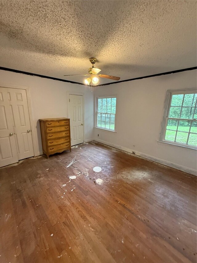 709 Highland Dr, Palestine, TX 75801 - unfurnished bedroom with hardwood / wood-style flooring, a textured ceiling, and ceiling fan