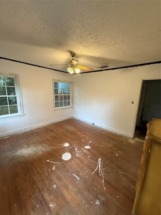 709 Highland Dr, Palestine, TX 75801 - spare room with a textured ceiling, hardwood / wood-style flooring, ceiling fan, and plenty of natural light