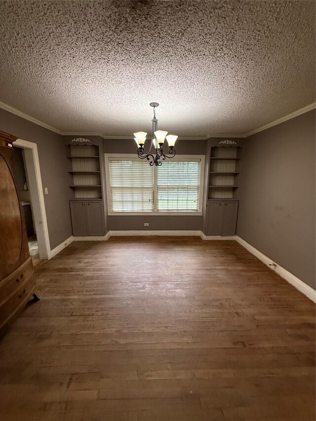 709 Highland Dr, Palestine, TX 75801 - unfurnished dining area with a textured ceiling, a chandelier, ornamental molding, and wood finished floors