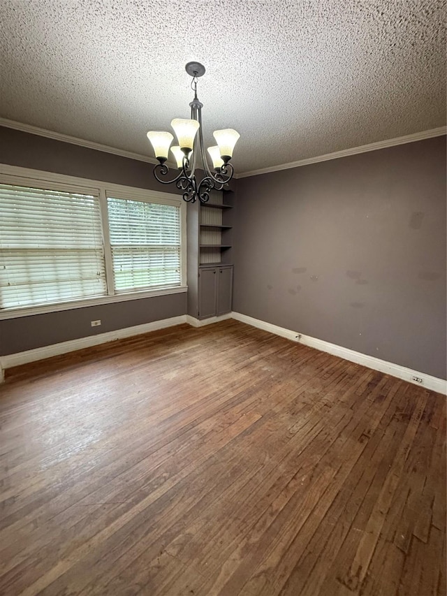 709 Highland Dr, Palestine, TX 75801 - spare room featuring a chandelier, crown molding, wood finished floors, and a textured ceiling