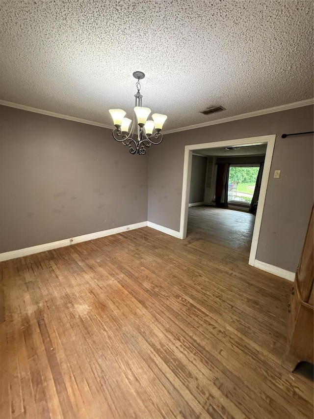 709 Highland Dr, Palestine, TX 75801 - empty room featuring ornamental molding, wood finished floors, a chandelier, and a textured ceiling
