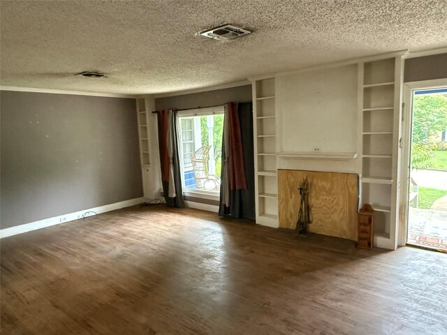 709 Highland Dr, Palestine, TX 75801 - unfurnished living room with a textured ceiling and wood finished floors