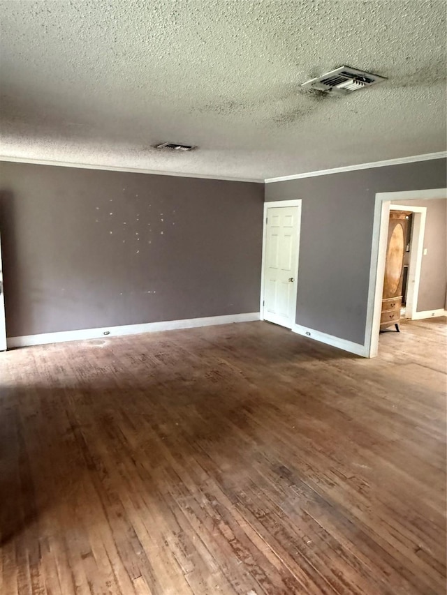 709 Highland Dr, Palestine, TX 75801 - unfurnished room with wood-type flooring, a textured ceiling, and crown molding