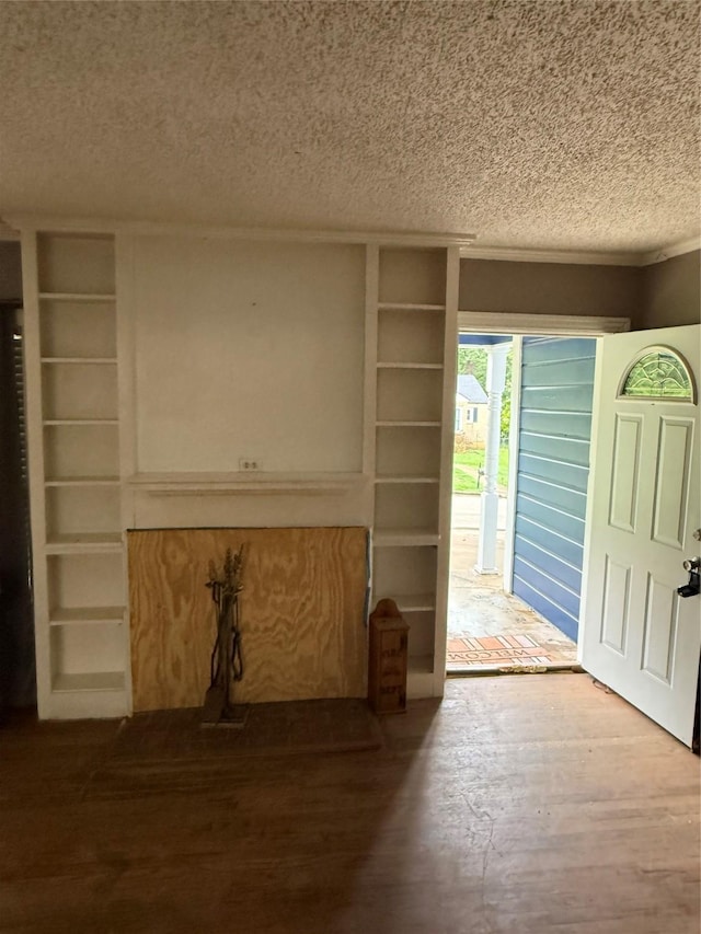 709 Highland Dr, Palestine, TX 75801 - unfurnished living room featuring a textured ceiling and wood finished floors